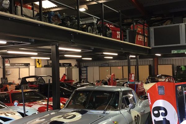 Classic racing cars storage with mezzanine floor above in West Sussex