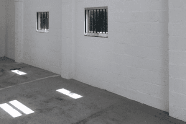 White breeze blocked brick wall with windows in Ringwood warehouse