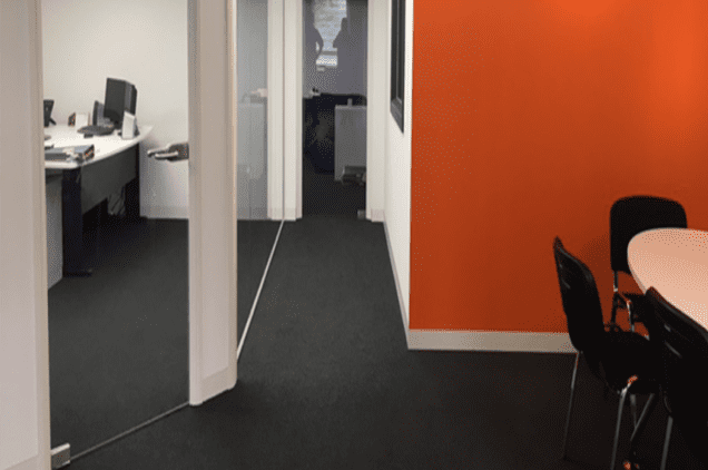 Office refurbishment with coloured partitioned walls, glass partitions and break table and chairs
