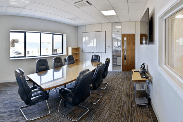 Meeting room with wooden table and leather chairs