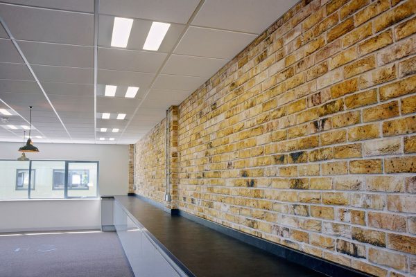 Brick styled wall by worktops in Ringwood office fit out