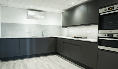 brightly lit kitchen area with dark appliances