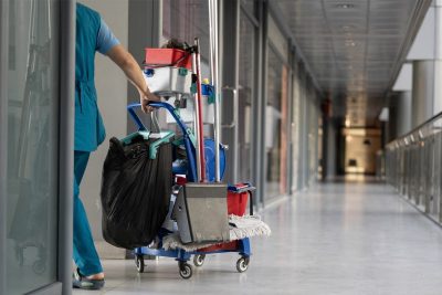 cleaner pull trolley along hallway